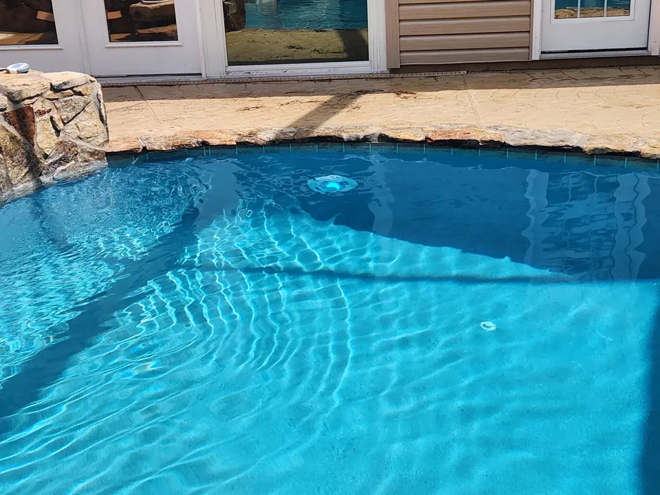 New Hayward ColorLogic LED pool light glowing blue in a Brooksville pool