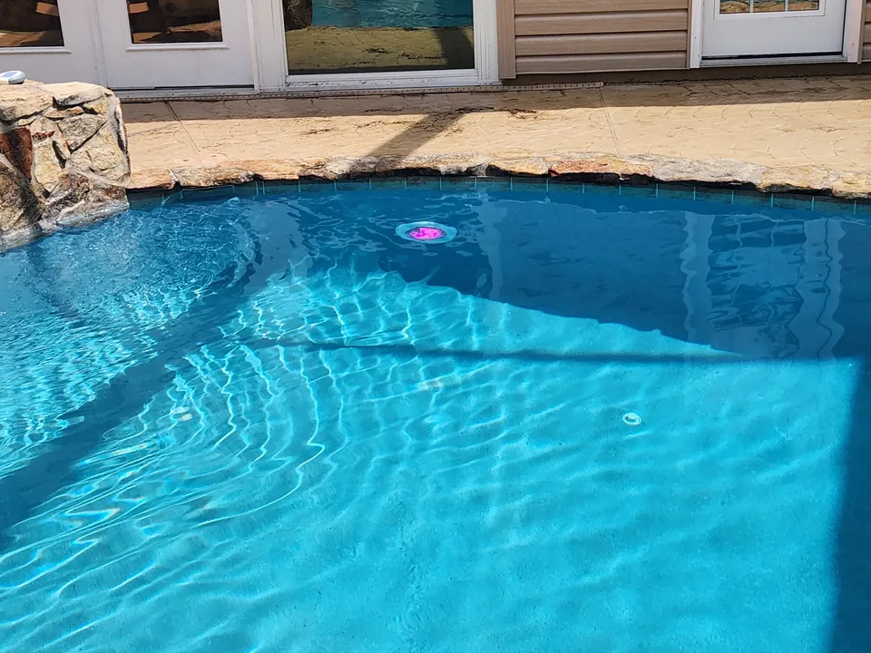 New Hayward ColorLogic LED pool light glowing magenta in a Brooksville pool