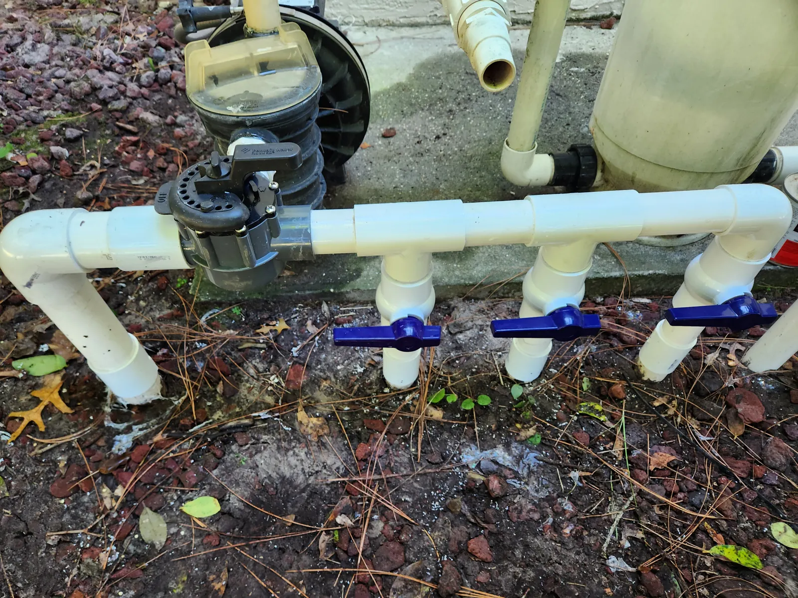 New diverter valves and plumbing on a pool equipment pad in Spring Hill