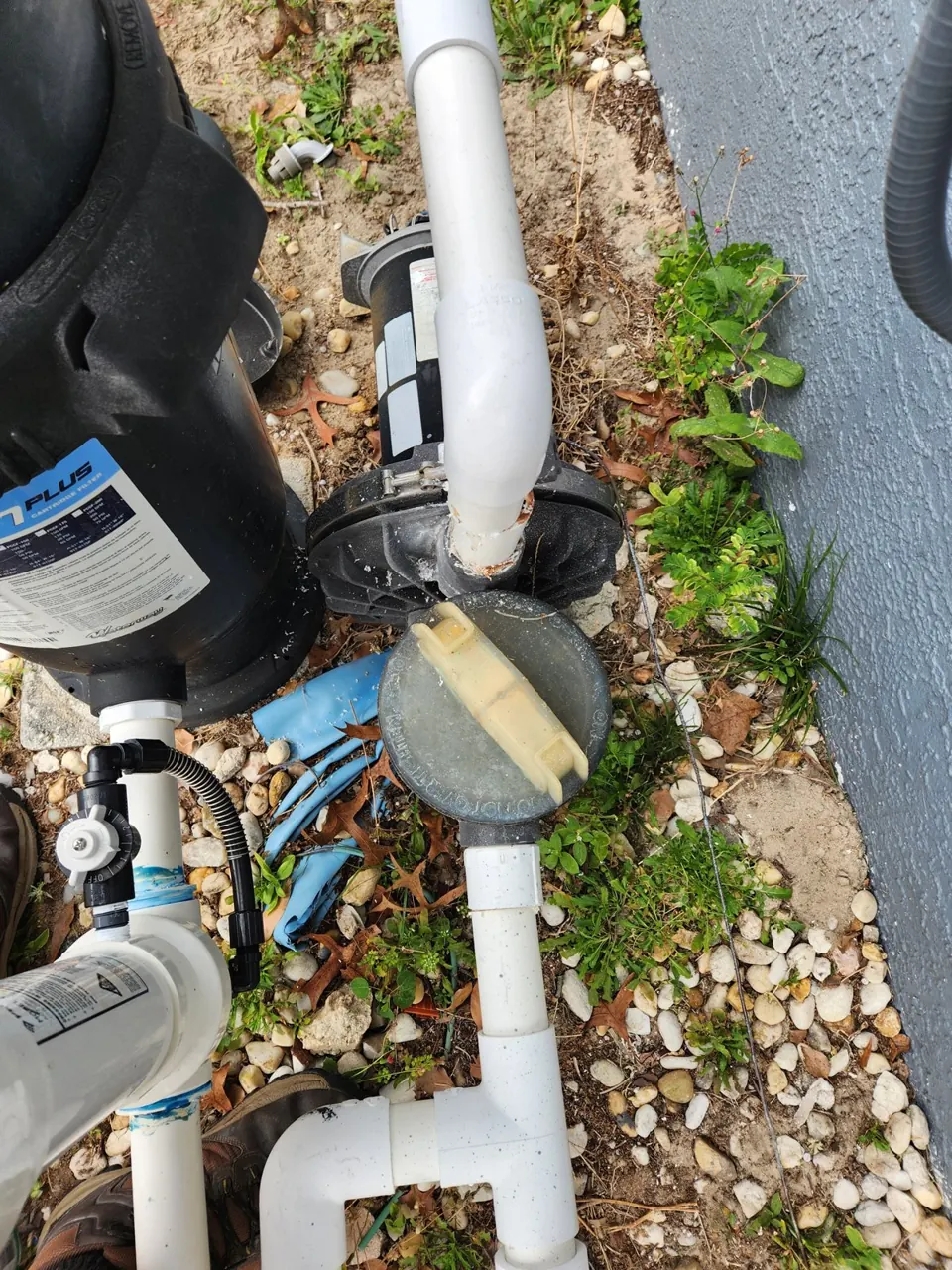 Old pool pump and plumbing before replacement at a Spring Hill home