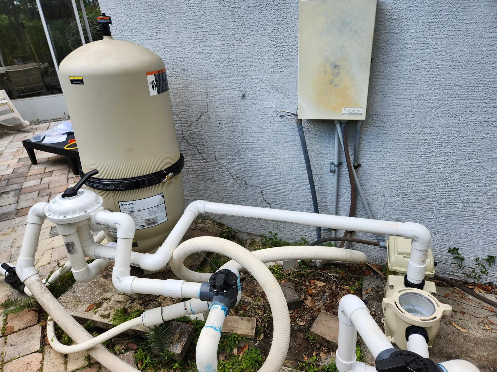 Wide view of a re-plumbed pool pump and filter in Brooksville